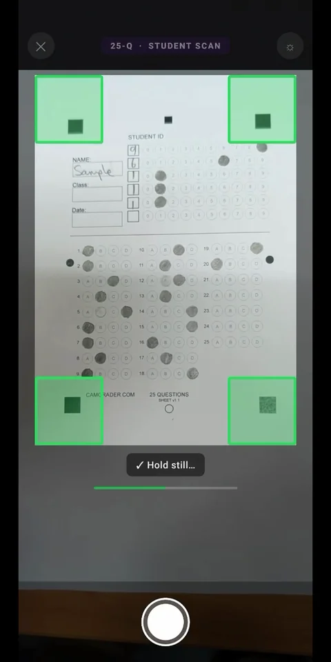 Scan camera view with all four corner alignment guides locked on and Hold still confirmation showing